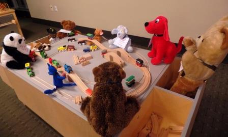 Child playing with train set.